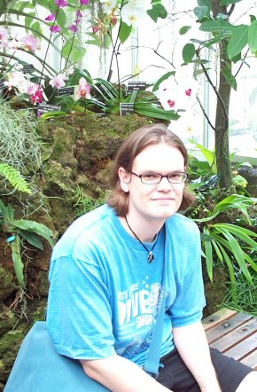 Andrew Posed With Orchids.jpg